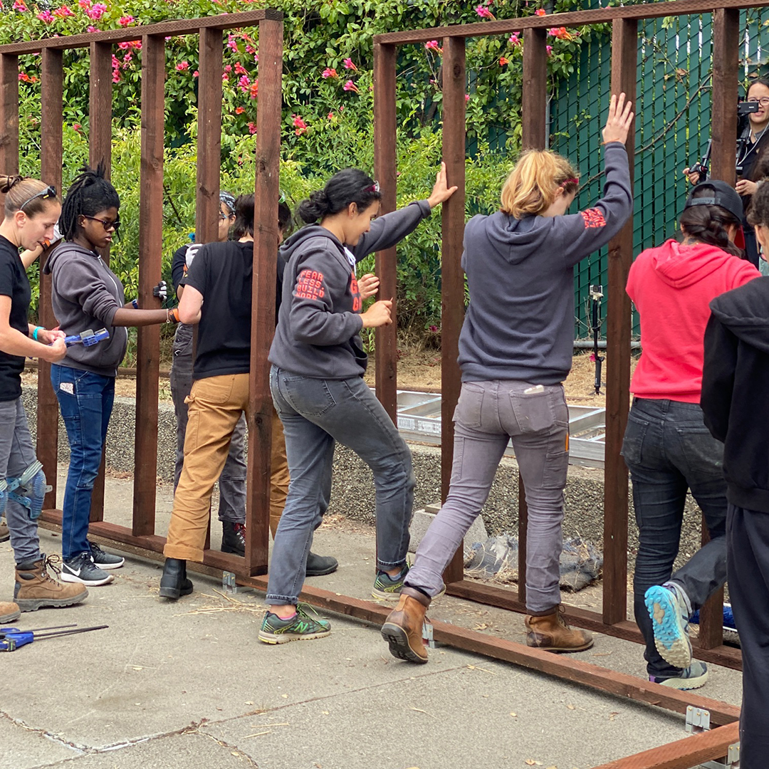 Girls Garage raise the wall for the greenhouse