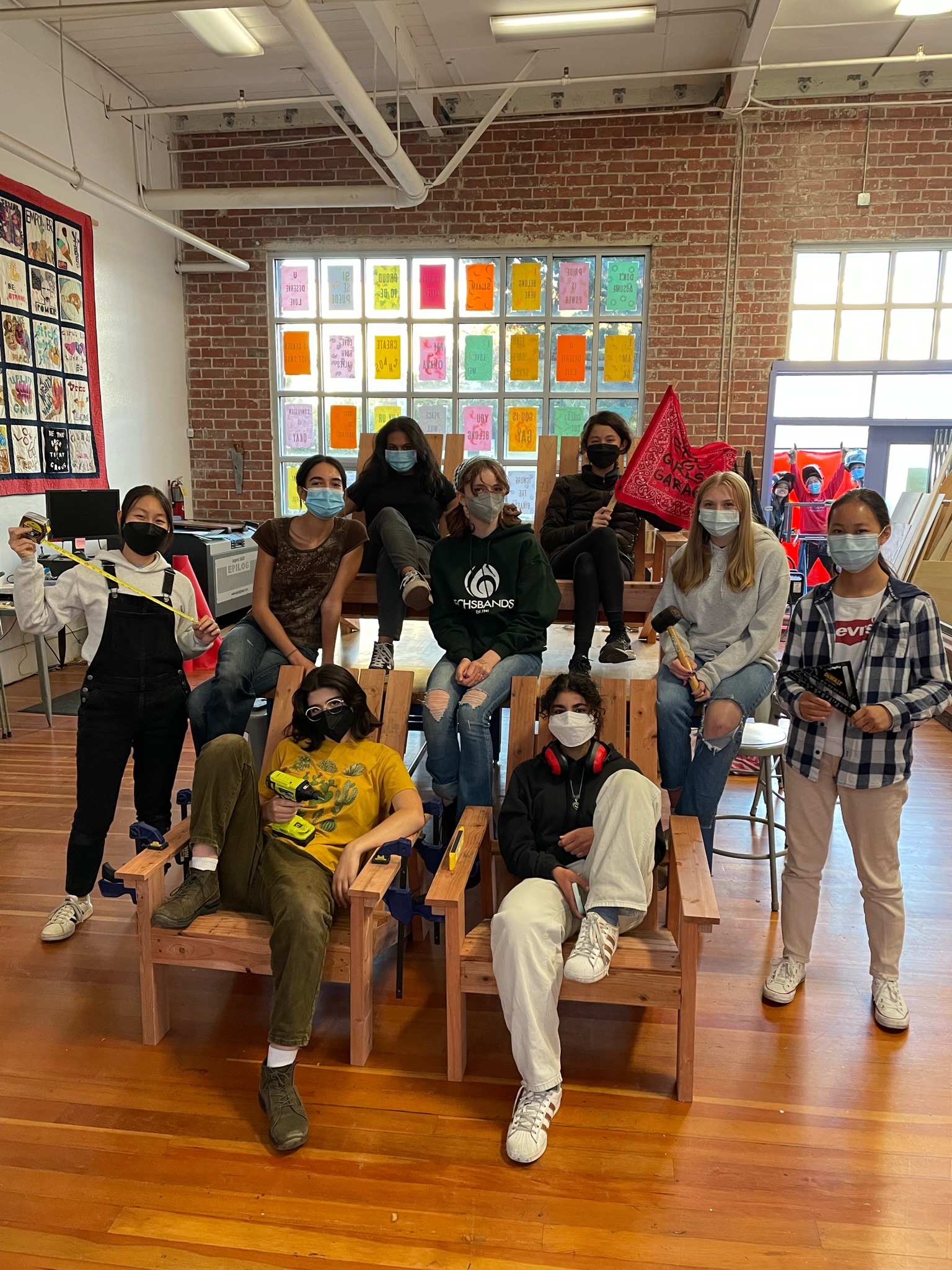 High school students with Adirondack chairs for Peoples Programs Oakland