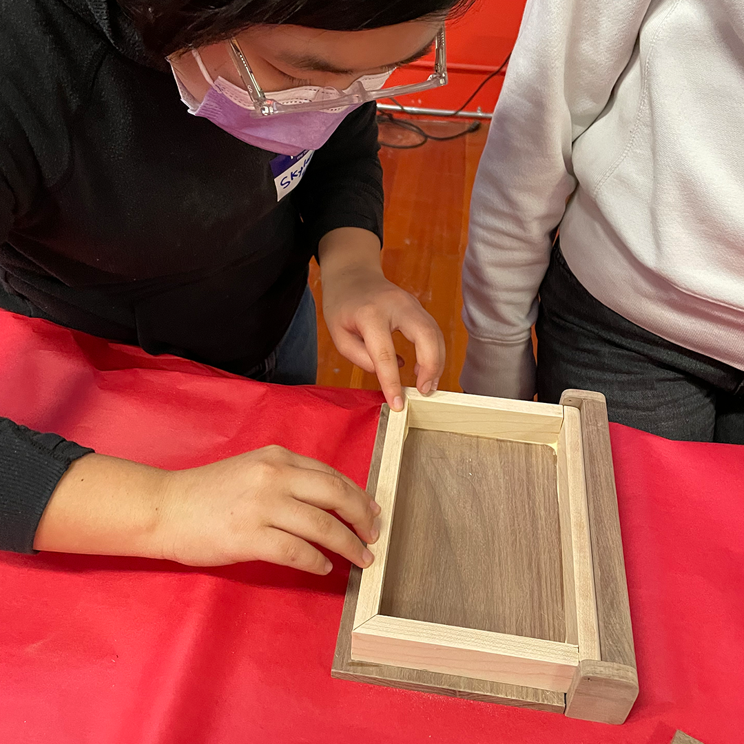 Student glues maple frame for secret book box