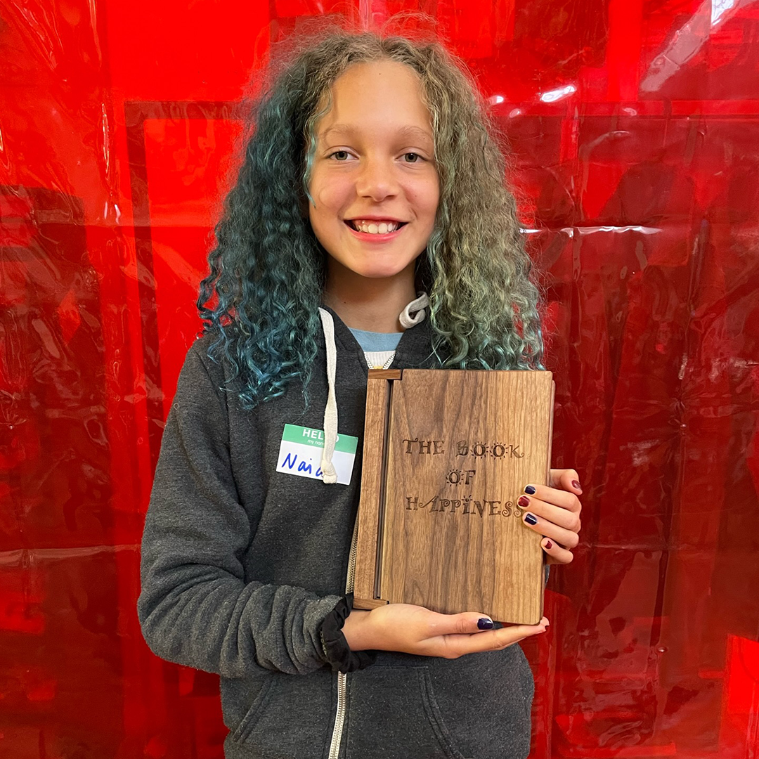 Student holding wooden book