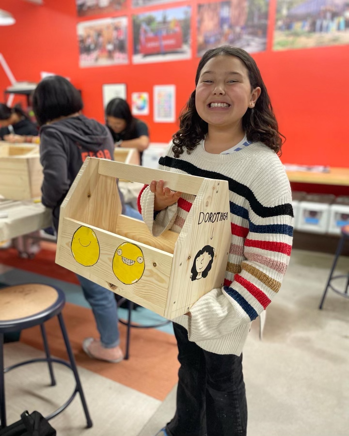 Student with wooden toolbox